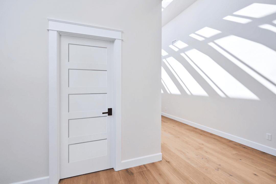 White door with sunlight casting shadows.