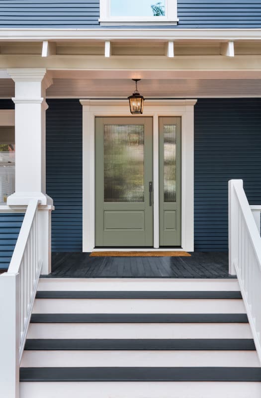 Front porch with blue siding and steps.
