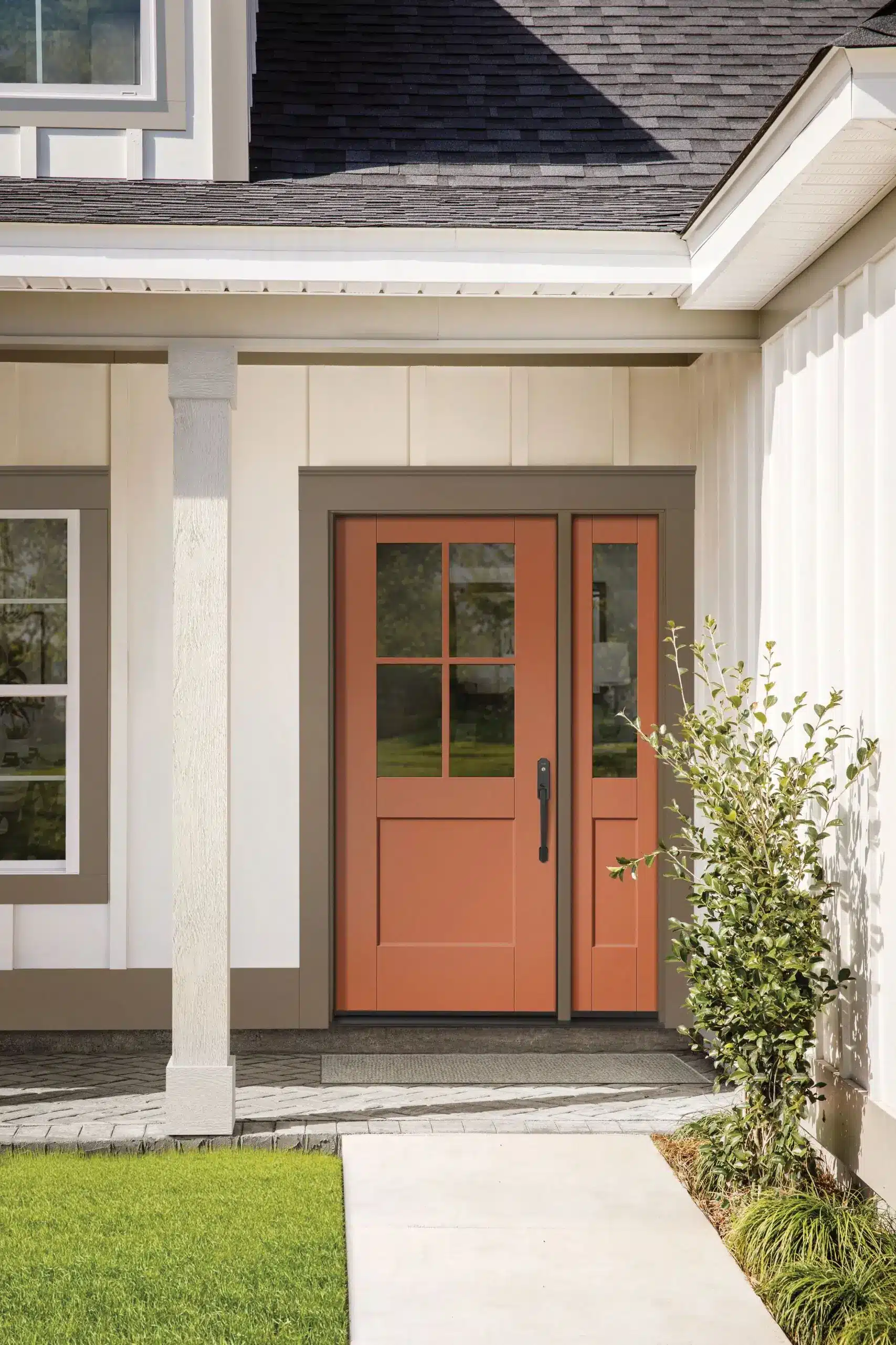 Orange front door on a modern house.